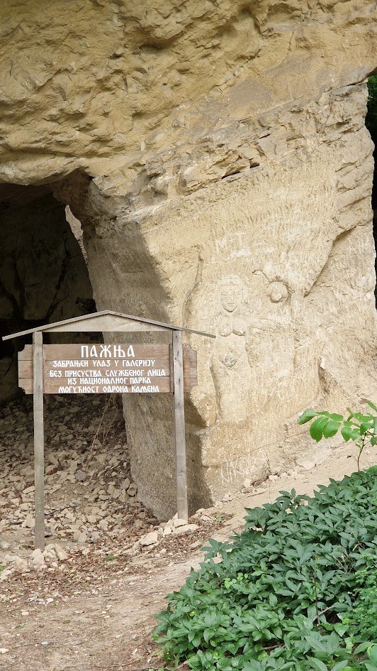 Entrance to the Beli Majdan gallery with the national park's warning sign