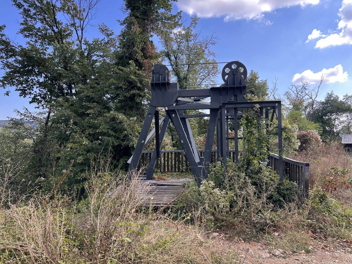 A steel mine headframe near the tower, a reminder of Vrdnik's coal-mining past